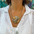 Collar de mujer color arena con medallón y cordon de cuero