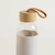 Botella de vidrio con tapa de bambú y funda de silicona | Crema en internet