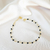 Pulseira com pedrinhas pretas banhada em ouro 18k - comprar online