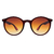 O Óculos de Sol Trindade Marrom Degradê possui um design arrojado e esportivo, em formato redondo, armação de acetato na cor marrom com detalhes vermelhos na ponteira e parte frontal. Lentes degradê marrom.