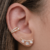 Brinco Ear Cuff com a base cravejada e 3 pedras de zircônia na cor cristal Banhado em ouro 18k - comprar online