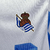 Camisa-Titular-Real-Sociedad-Home-23-24-Macron-Branco-e-Azul-Masculina-Torcedor-La-Liga-Futebol-Espanhol-Los-Txuri-urdin-