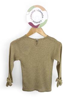 Blusa em lurex dourado manga longa com detalhes em laços nas manhas e no lado esquerdo do peito Paola da Vinci Tam 2 usado em bom estado - comprar online