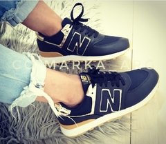 New balance negras doradas discount