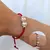 PULSERA GAMUZA ROJA CON 2 BOLITAS