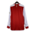 camisa-arsenal-manga-longa-home-titular-vermelha-branca-patrocinio-adidas-temporada-2023-2024-raios-faixas-laterais-W-D-invicta-gola-redonda-punhos-Emirates-Visit-Rwanda-logo-escudo-calção-meiões. 