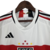 Camisa-branca-São-Paulo-Adidas-temporada-2023-2024-listras-horizontais-vermelho-preto-escudo-logo-da-Adidas-Sportsbet.io-calção-branco-meiões-brancos. 