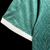 camisa-masculina-home-Kappa-Guarani-temporada-2023-2024-Alma-Indígena-verde-estampas-grafismos-indígenas-gola-V-branco-punhos-OMINI-escudo-tecido-Kombat-resistência-respirabilidade 