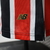  camisa-player-São-Paulo-Away-24-25-patrocinio-New-Balance-tradicional-design-listrado-vertical-vermelho-preto-gola-mangas-faixas-brancas-Tricolor-escudo-frase-história-dourado-logo-selo-Made-in-Cotia-calção-meiões. 