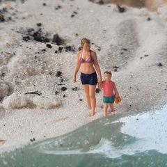 Mãe e Filha Andando de Mãos Dadas na Praia