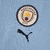 CAMISA-MANCHESTER-CITY-1-HOME-2022-2023-TORCEDOR-PUMA-FEMININA-AZUL-GOLA-REDONDA-PNG