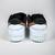 O tênis Nike Dunk Low SB x Polaroid é uma colaboração entre a Nike e a Polaroid, empresa conhecida por suas câmeras fotográficas instantâneas. O modelo apresenta uma combinação de cores preto e arco-íris, que fazem referência à icônica marca registrada da