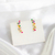 Brinco Ear Cuff Zélia com Detalhe de Borboleta e Flor Cravejado com Zircônias Coloridas Folheado a Ouro 18k