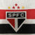 Camisa Titular Feminina São Paulo FC Adidas 2024/25 branca com listras horizontais em vermelho e preto, escudo do São Paulo FC no centro do peito, gola polo com detalhes tricolores nas pontas e corte frontal em V, punhos com detalhes em vermelho e preto, 