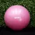 Pelota de esferodinamia rosa de 65 cm Get Fit! frente a un fondo de hojas verdes.