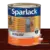 Cylinder can of Sparlack marine varnish designed for exterior use, showcasing a wooden surface with a window.