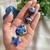 A hand gracefully presents a collection of mini crystal sphere, pyramid, star, and heart-shaped Sodalite stones, symbolizing clarity, balance, and deep inner wisdom. Embrace these crystals to enhance your mental focus and intuitive capabilities.