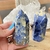 A photo of a Sodalite Point, a polished crystal crafted from natural sodalite stone. This exquisite crystal promotes mental clarity and elevated spiritual awareness, making it ideal for professionals seeking insight, intuition, and improved communication.