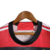 Detalhe do colarinho da camisa regata Flamengo I 23/24, vermelha e preta, com logo da Adidas.