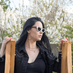 mujer luciendo anteojos de sol de madera(patillas) y acetato (frente) con lentes polarizados modelo Malibu. Estilo pin up. Marca Nomade