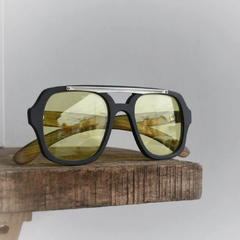 anteojos de madera (patillas), acetato (frente) color negro y aplique de acero inoxidable con lentes tintados color amarillo estilo aviador vista frente | Nomade