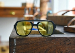 anteojos de madera (patillas), acetato (frente) color negro y aplique de acero inoxidable con lentes tintados color amarillo vista frente | Nomade