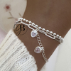 PU 801 - Pulsera doble corazones CRISTAL (ACERO BLANCO)