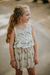 Nena con blusa Hortensia beige, estampada con breteles de puntilla, combinado con falda Lavanda haciendo conjunto