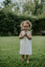 Nena con vestido Girasol off white, de micropanal con detalle de puntilla en escote