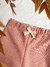 Detalle del Pantalon canaima rosa, con moño de puntilla en cintura