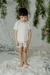 Nene con short Morus, con rayas verde, combinado con remera Geranio off white