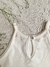 Remera lirio off white, de micropanal, escote halter con puntilla en el escote y boton de nacar en espalda