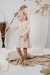 Nena con vestido savernake, de algodon estampado en beige con rosa