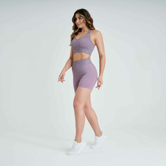 Modelo usando shorts feminino rosa mescla da linha Marcio May Sports, ideal para atividades físicas.