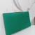 Bolsa clutch quadrada verde esmeralda com courino texturizado, com puxador em formato diamante dourado na internet
