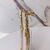 Brinco ear cuff de franjas dourado e pedras prata na base dourada - loja online