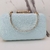 Clutch azul turquesa com brilho furta cor e detalhes em dourado - comprar online