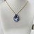 Conjunto colar e brinco pedra gota G azul grisaceo, base dourada - loja online