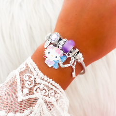 PULSERA CON CHARMS ¨KITTY CUBIC VIOLETA¨ - comprar online